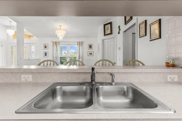 a kitchen with stainless steel appliances kitchen island granite countertop a sink and cabinets