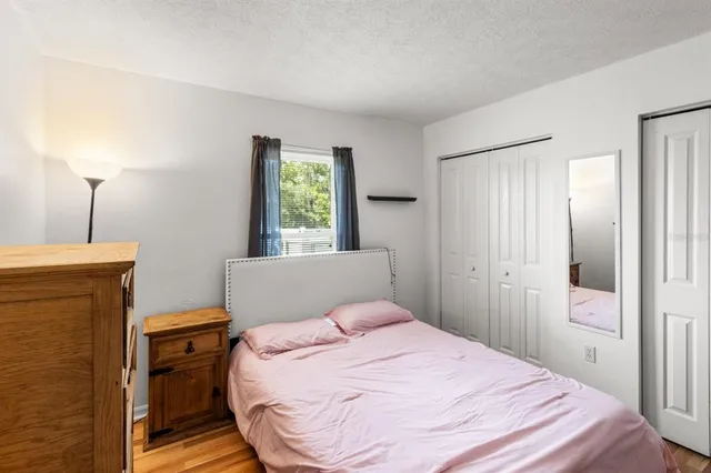 a bedroom with a bed and a television