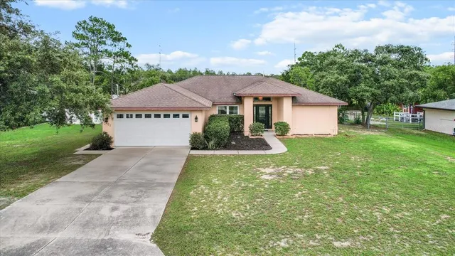 a view of a swimming pool with an outdoor seating and a yard