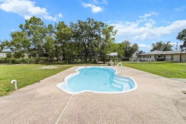 a view of a swimming pool and a yard