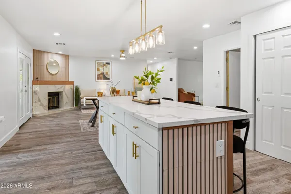 a living room with furniture a mirror and a fireplace