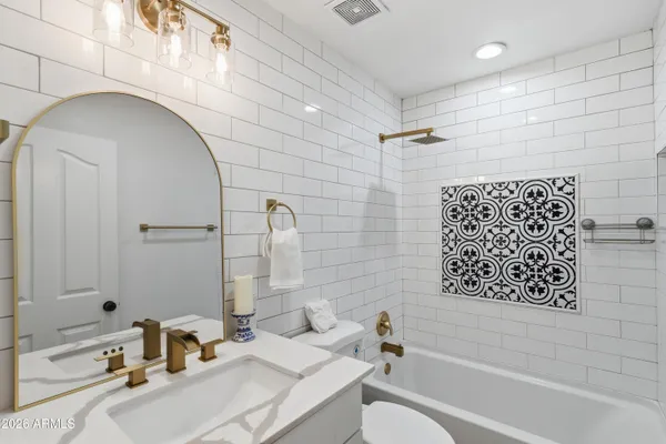 a living room with furniture flowerpot and wooden floor
