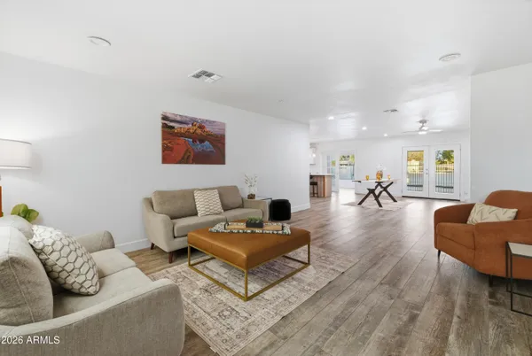 a living room with furniture a fireplace and a table