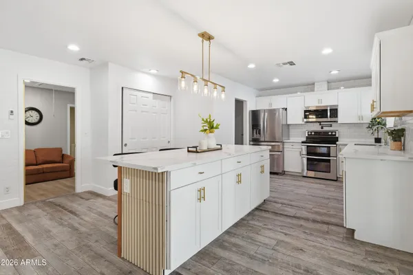 a living room with furniture a mirror and a fireplace