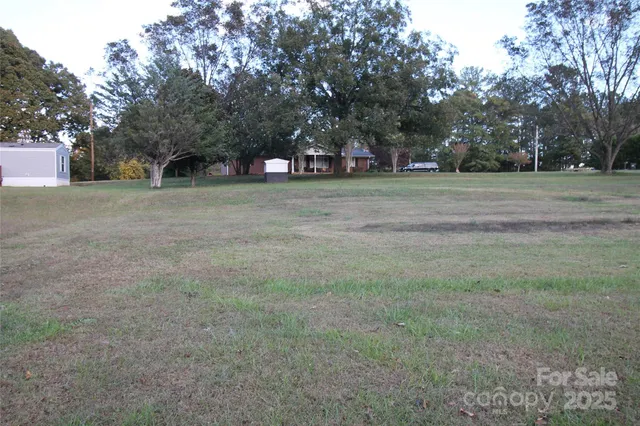 a front view of house with yard and trees