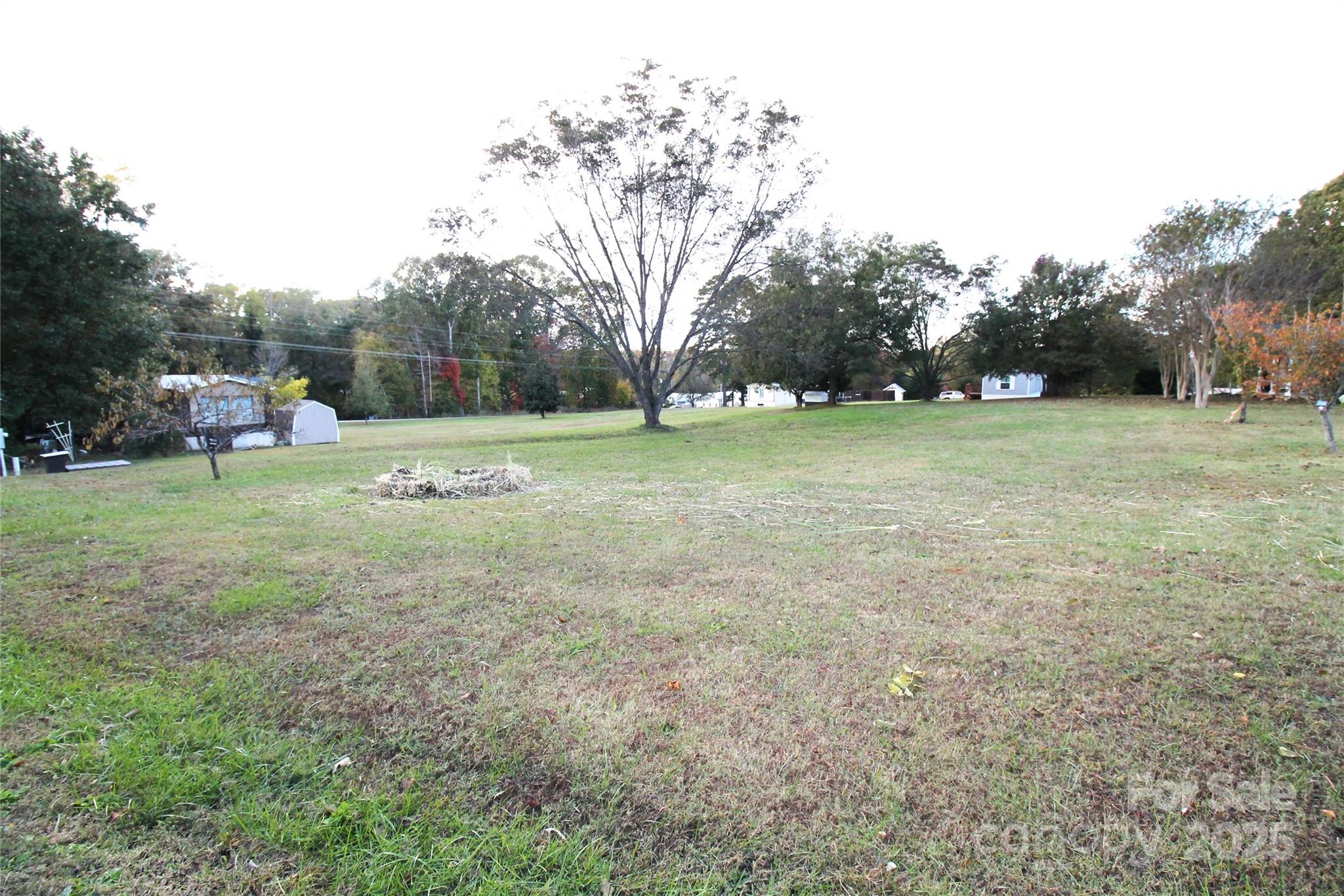 203 Ratchford Farm Road Gastonia, NC 28056 - Photo 14 of 16 a view of field with trees in the background