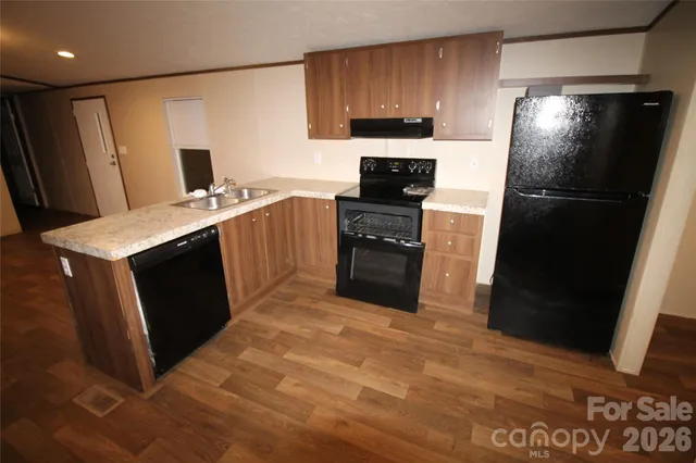 an empty room with wooden floor and a window