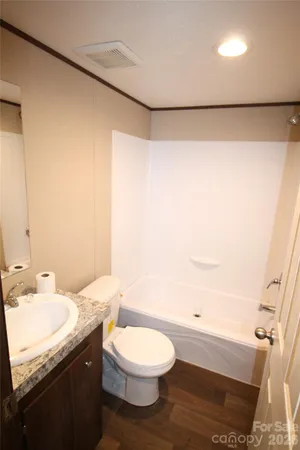 a view of an empty room with a kitchen