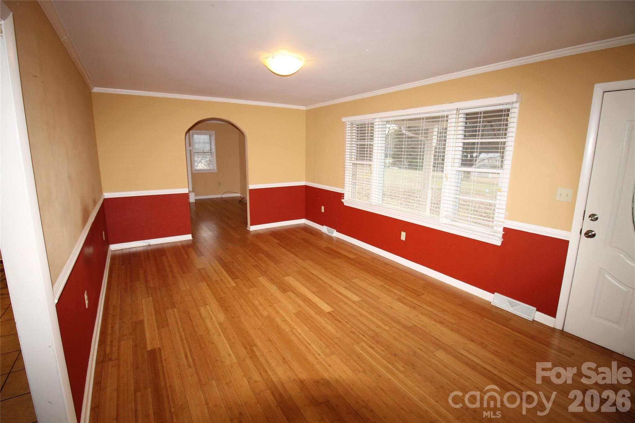203 Ratchford Farm Road Gastonia, NC 28056 - Photo 2 of 25 a view of an empty room with wooden floor and a window
