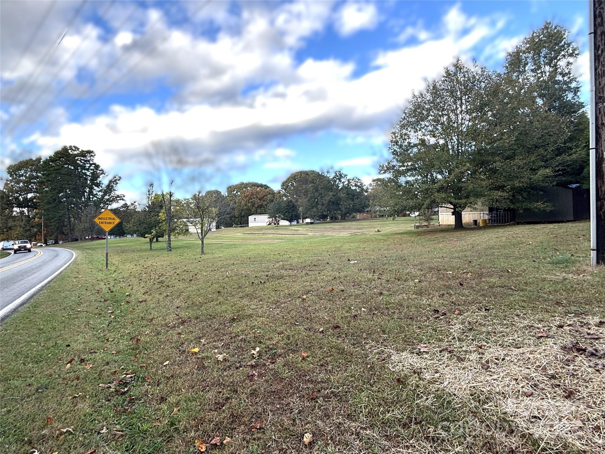 203 Ratchford Farm Road Gastonia, NC 28056 - Photo 2 of 16 a view of a green field with trees in the background