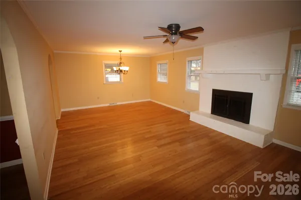 wooden floor in an empty room with a fireplace