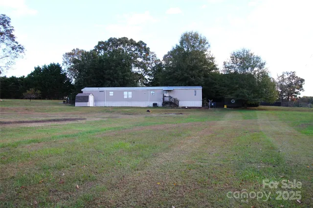 a view of a tiny house with a yard