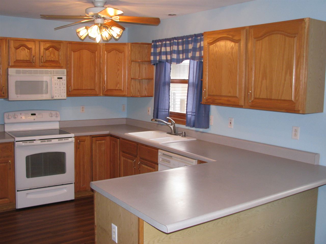 1123 South Weldon Road Rockford, IL 61102 - Photo 3 of 19 a kitchen with stainless steel appliances a stove a sink and a microwave