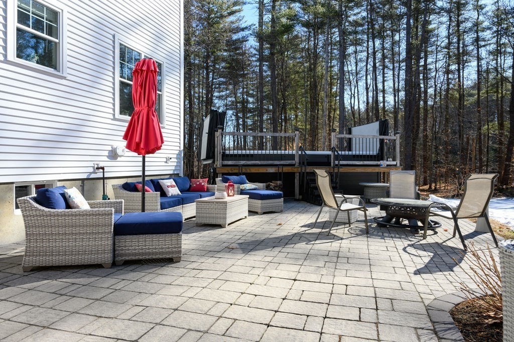 600 Wethersfield Street Rowley, MA 01969 - Photo 12 of 42 a living room with patio furniture and a fireplace