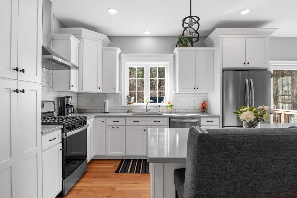 600 Wethersfield Street Rowley, MA 01969 - Photo 18 of 42 a kitchen with a sink stove and refrigerator