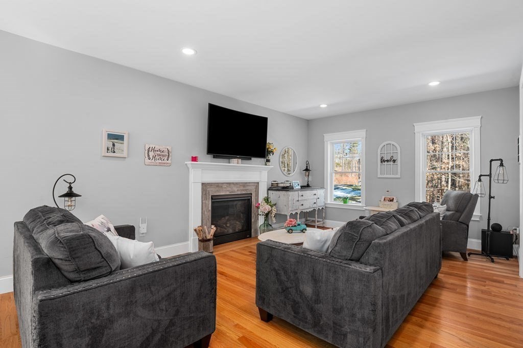 600 Wethersfield Street Rowley, MA 01969 - Photo 22 of 42 a living room with furniture a flat screen tv and a fireplace