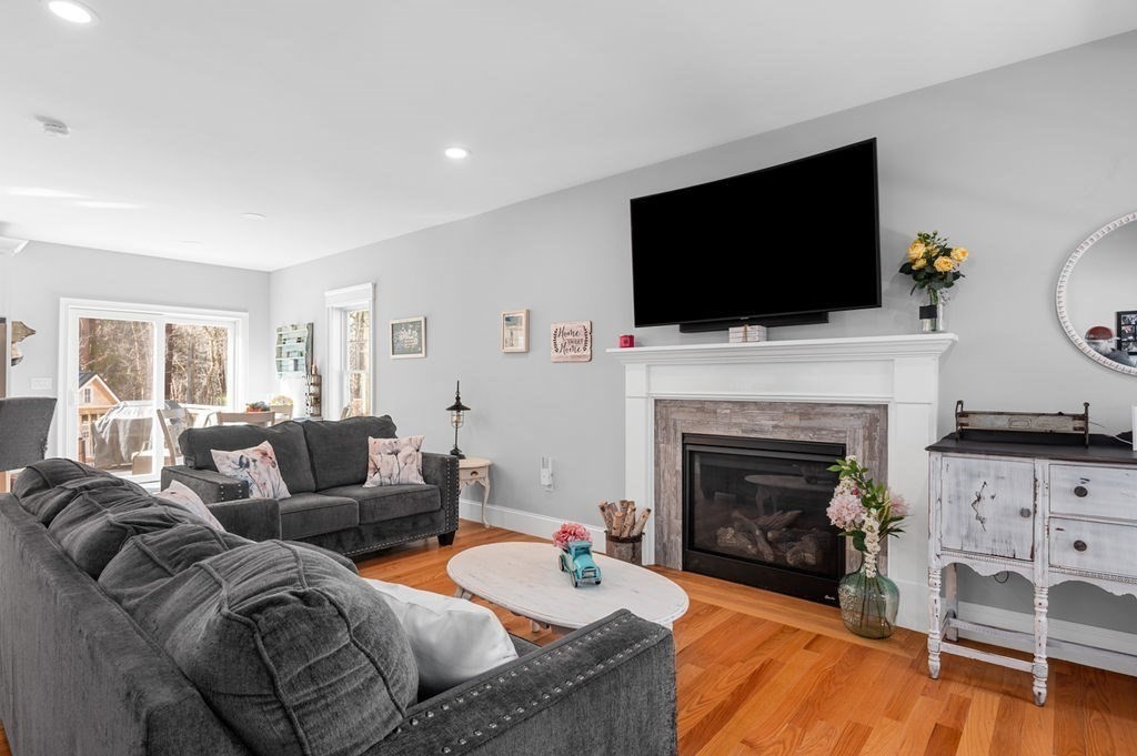 600 Wethersfield Street Rowley, MA 01969 - Photo 23 of 42 a living room with furniture a flat screen tv and a fireplace