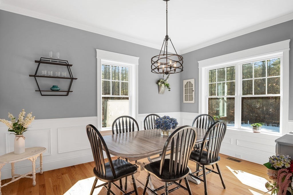 600 Wethersfield Street Rowley, MA 01969 - Photo 28 of 42 a view of a dining room with furniture a chandelier and wooden floor