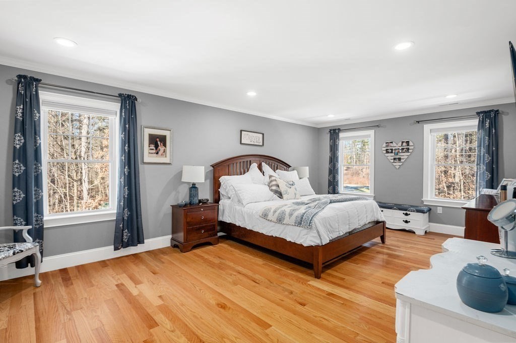 600 Wethersfield Street Rowley, MA 01969 - Photo 30 of 42 a spacious bedroom with a bed couch and windows