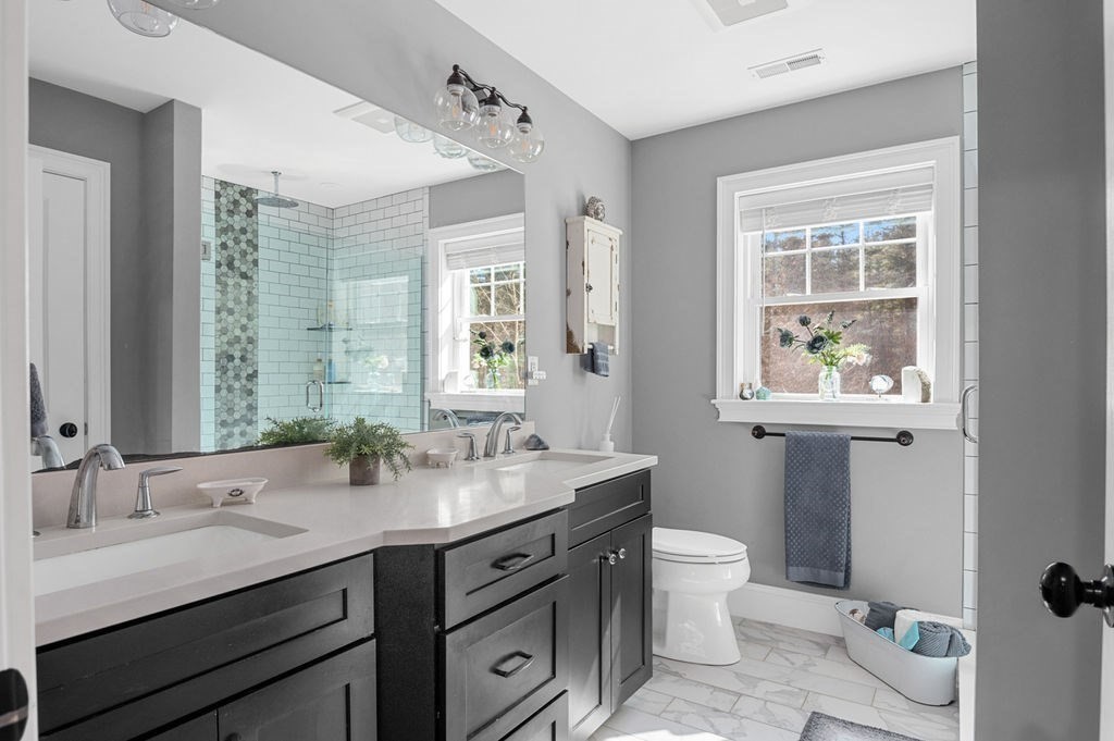 600 Wethersfield Street Rowley, MA 01969 - Photo 32 of 42 a bathroom with a granite countertop sink mirror and a toilet