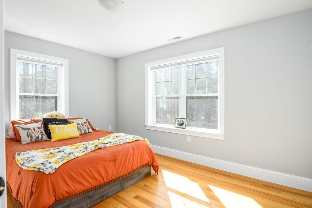 600 Wethersfield Street Rowley, MA 01969 - Photo 35 of 42 a bedroom with a bed and wooden floor