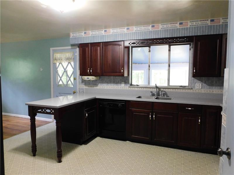 968 Chapel Road Monaca, PA 15061 - Photo 7 of 23 Spacious kitchen with dark stain cabinets.