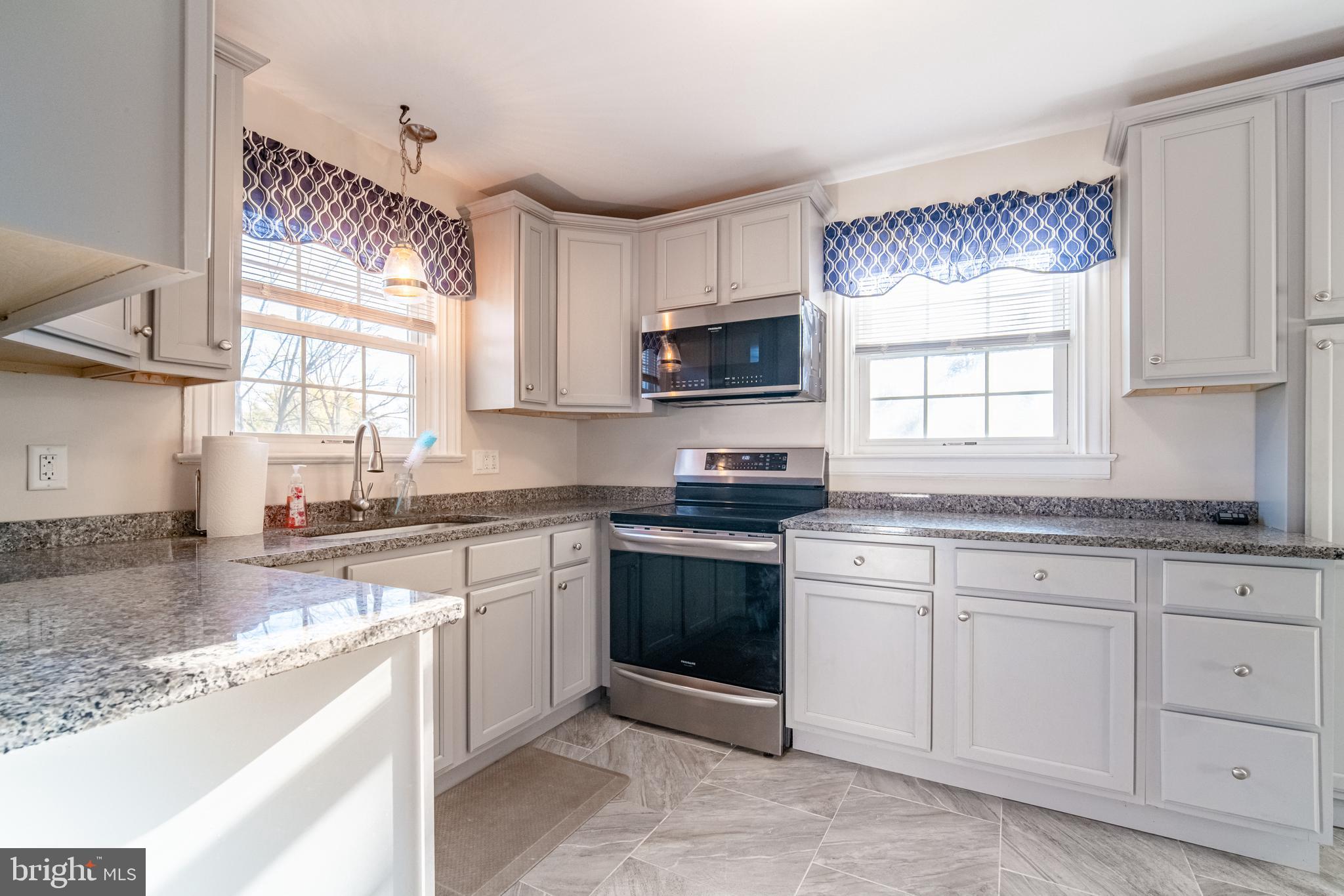 550 East Canal Road York, PA 17404 - Photo 11 of 32 a kitchen with cabinets appliances a sink and a window