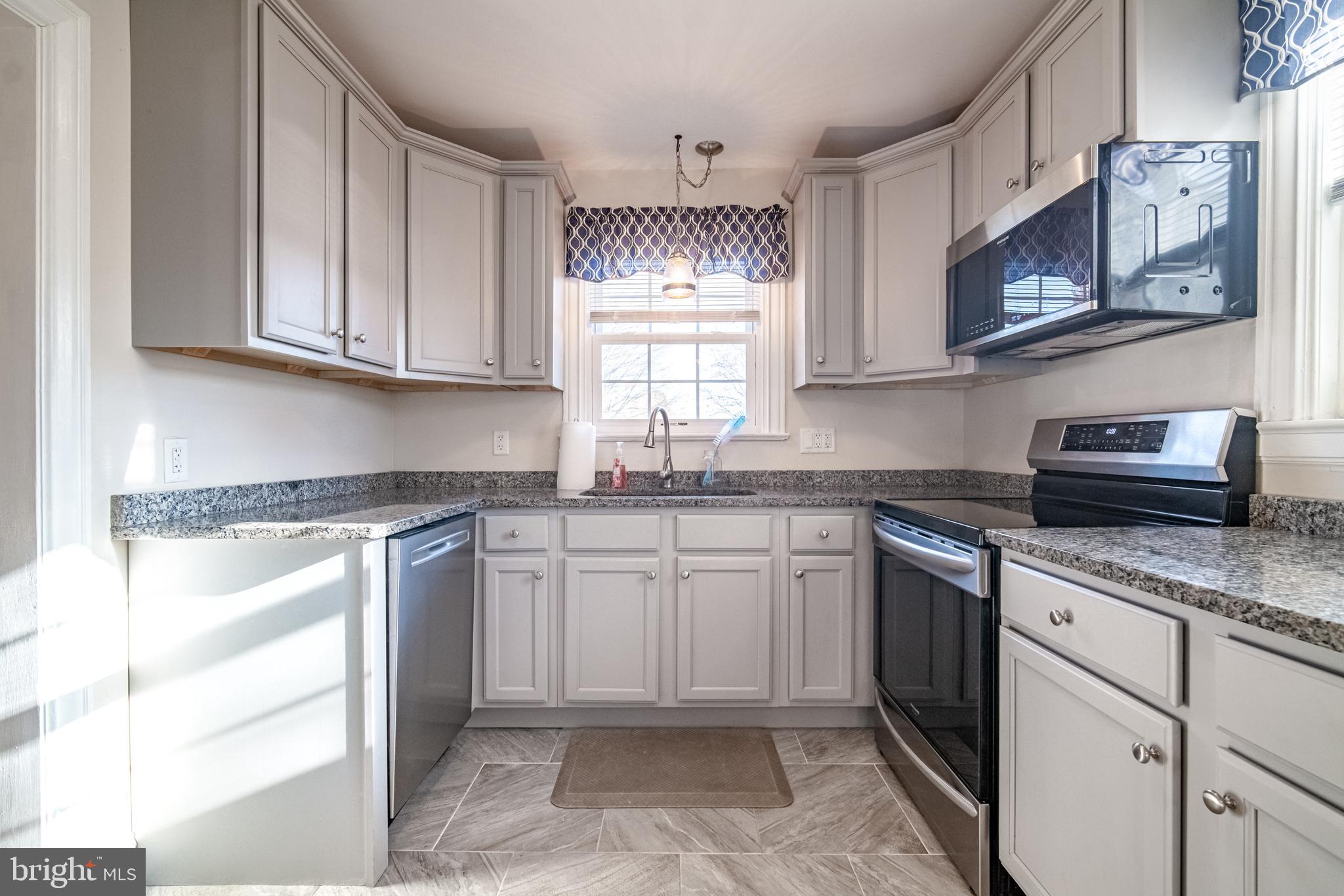 550 East Canal Road York, PA 17404 - Photo 12 of 32 a kitchen with stainless steel appliances granite countertop a sink stove and cabinets