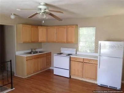 a kitchen with a stove a sink and a refrigerator