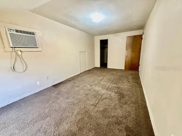 a view of a room with wooden floor and glass door