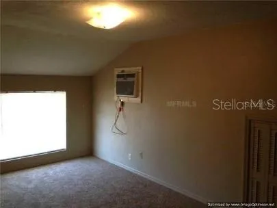a view of a room with window and ceiling fan