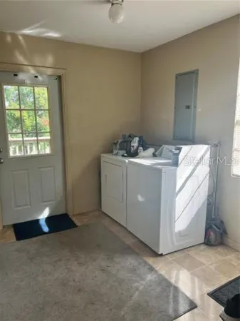 a utility room with closet dryer and washer