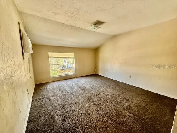 a view of an empty room and a window