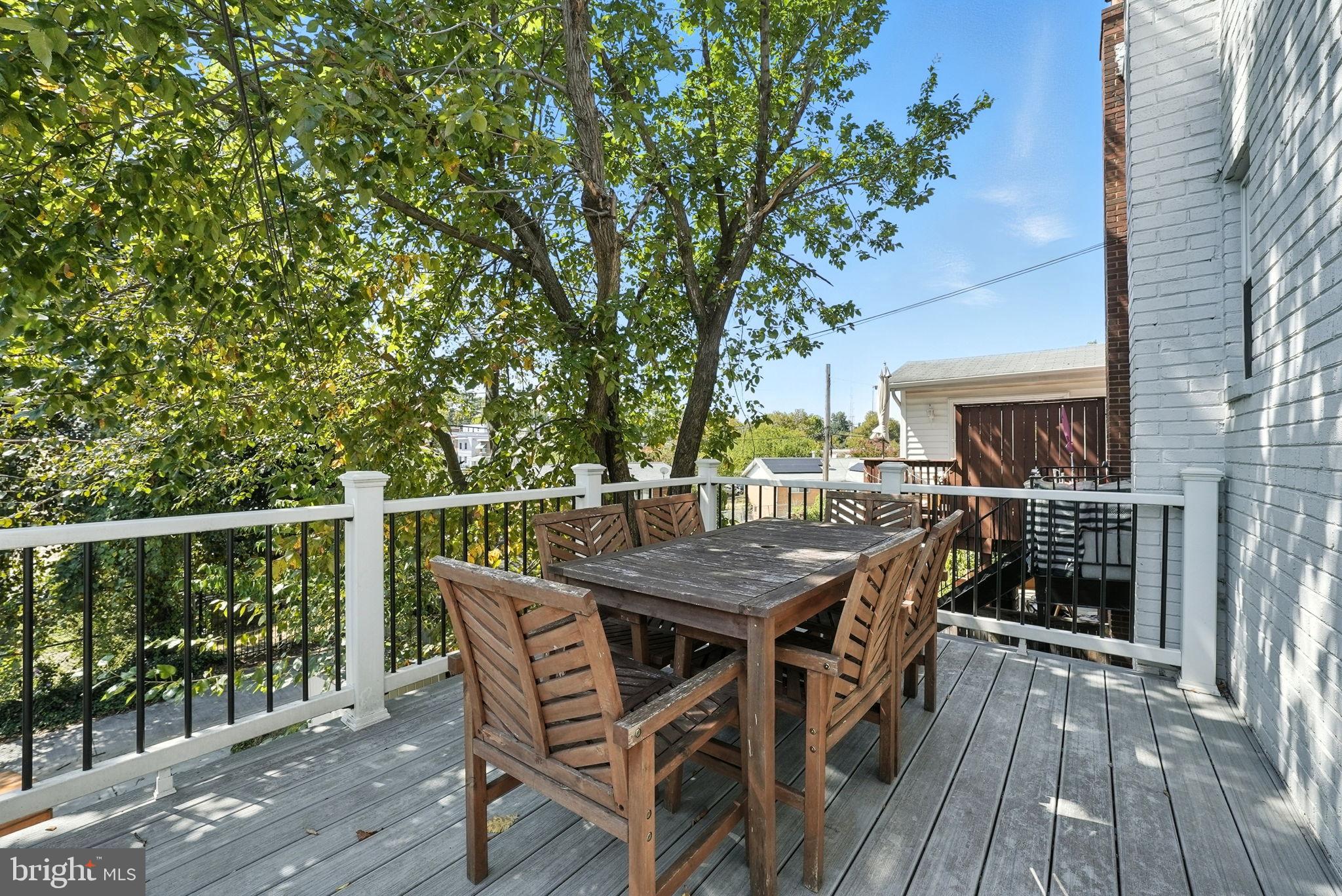 835 Oglethorpe Street Northeast Washington, DC 20011 - Photo 5 of 22 a terrace with outdoor seating and wooden floor