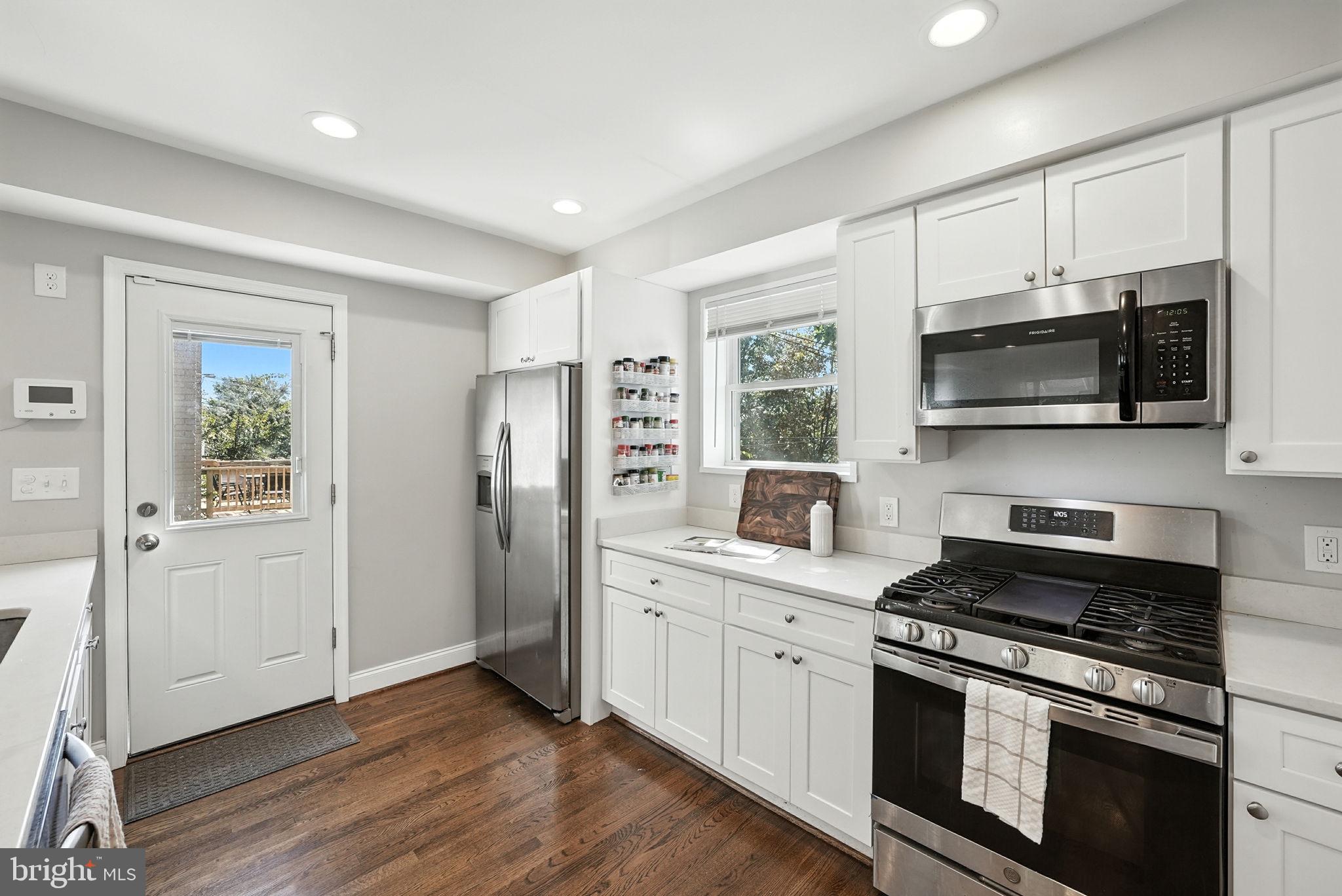 835 Oglethorpe Street Northeast Washington, DC 20011 - Photo 7 of 22 a kitchen with stainless steel appliances a stove microwave and refrigerator