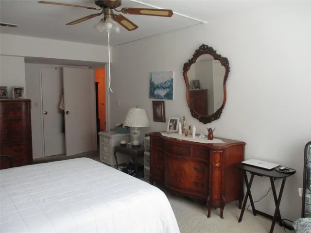 a bedroom with a bed and a mirror