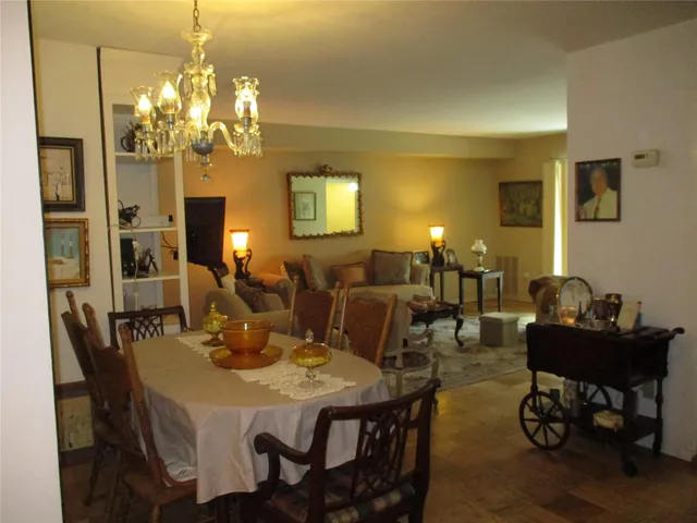 a view of a dining room with furniture and chandelier