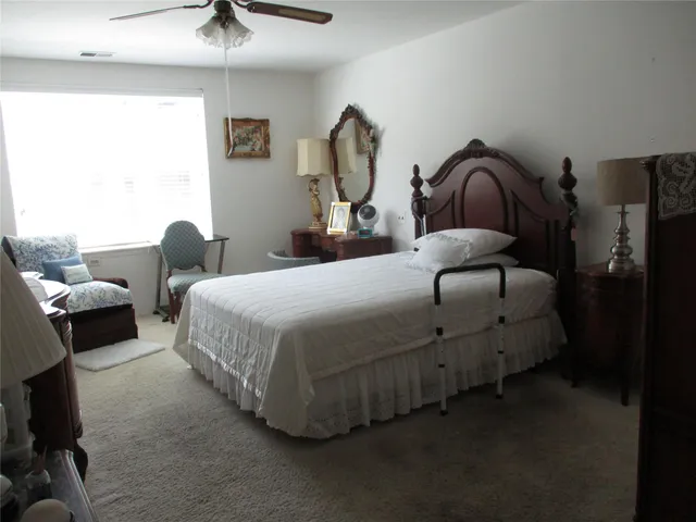 a bedroom with bed and a chandelier