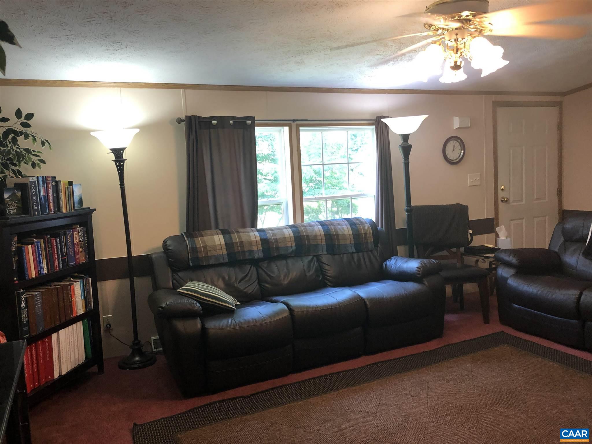 583 Rippin Run Road Ruckersville, VA 22968 - Photo 4 of 28 a living room with furniture and a book shelf