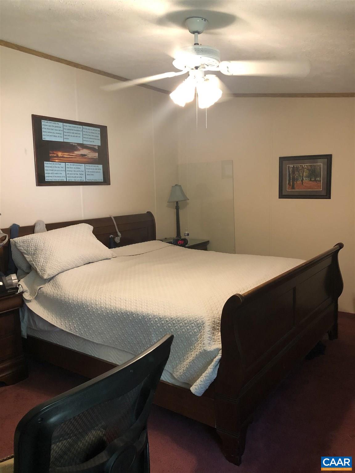 583 Rippin Run Road Ruckersville, VA 22968 - Photo 8 of 28 a bedroom with a bed and a chandelier