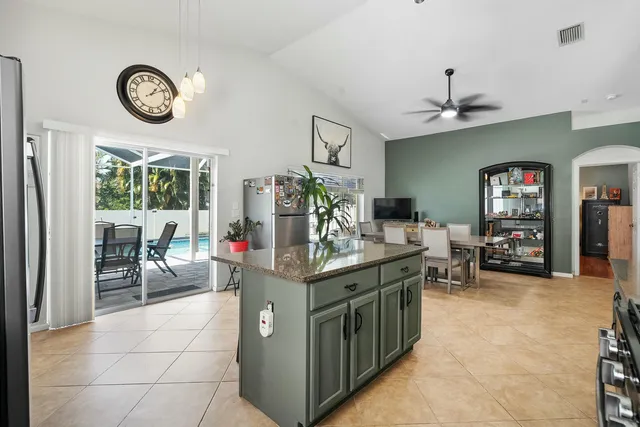 a view of kitchen with sink and refrigerator