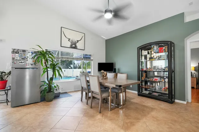 a dining room with furniture and a potted plant