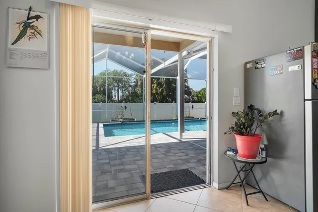 a porch with a table and chairs