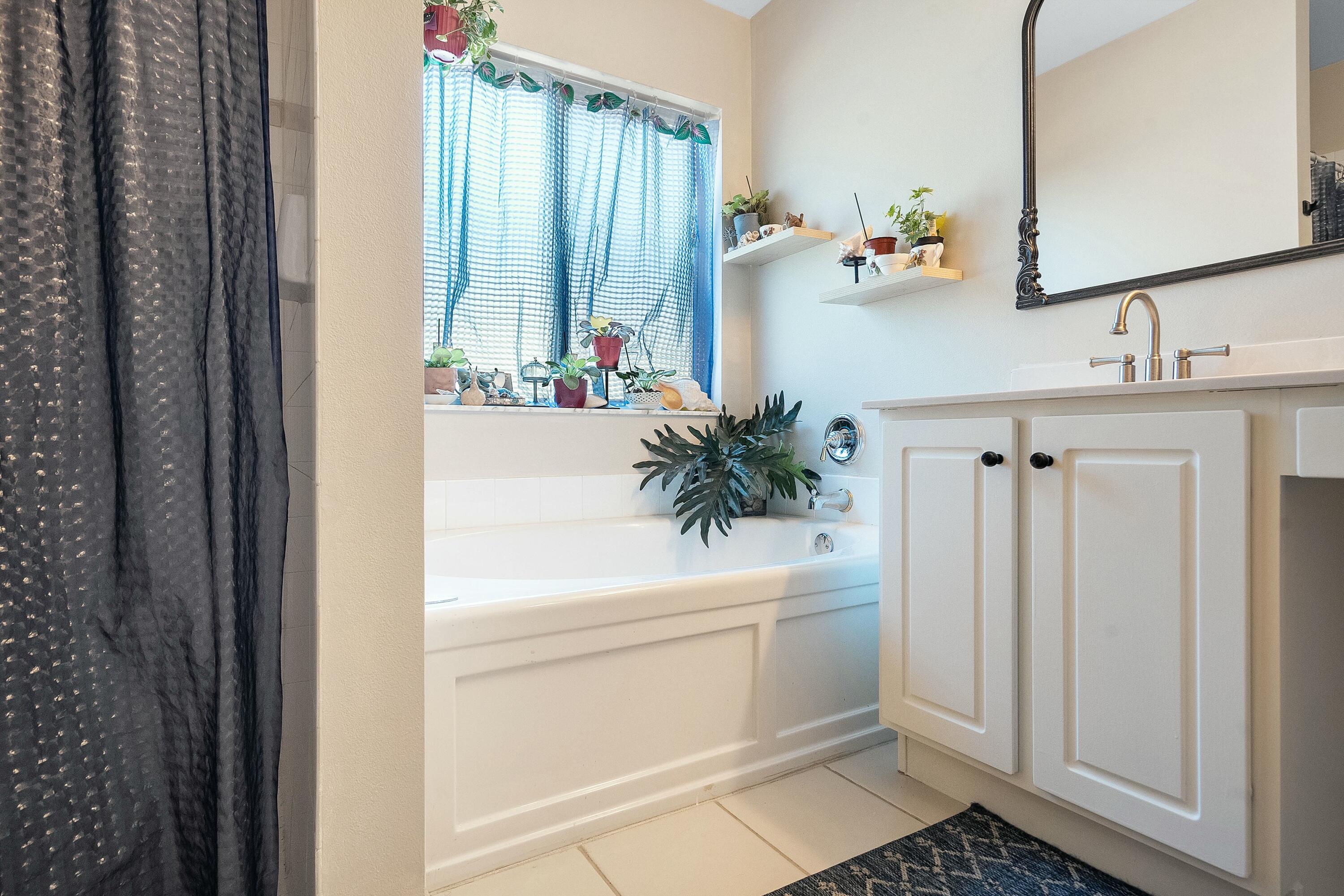 2480 Southeast Springtree Place Stuart, FL 34997 - Photo 19 of 39 a bathroom with a sink a toilet and a mirror