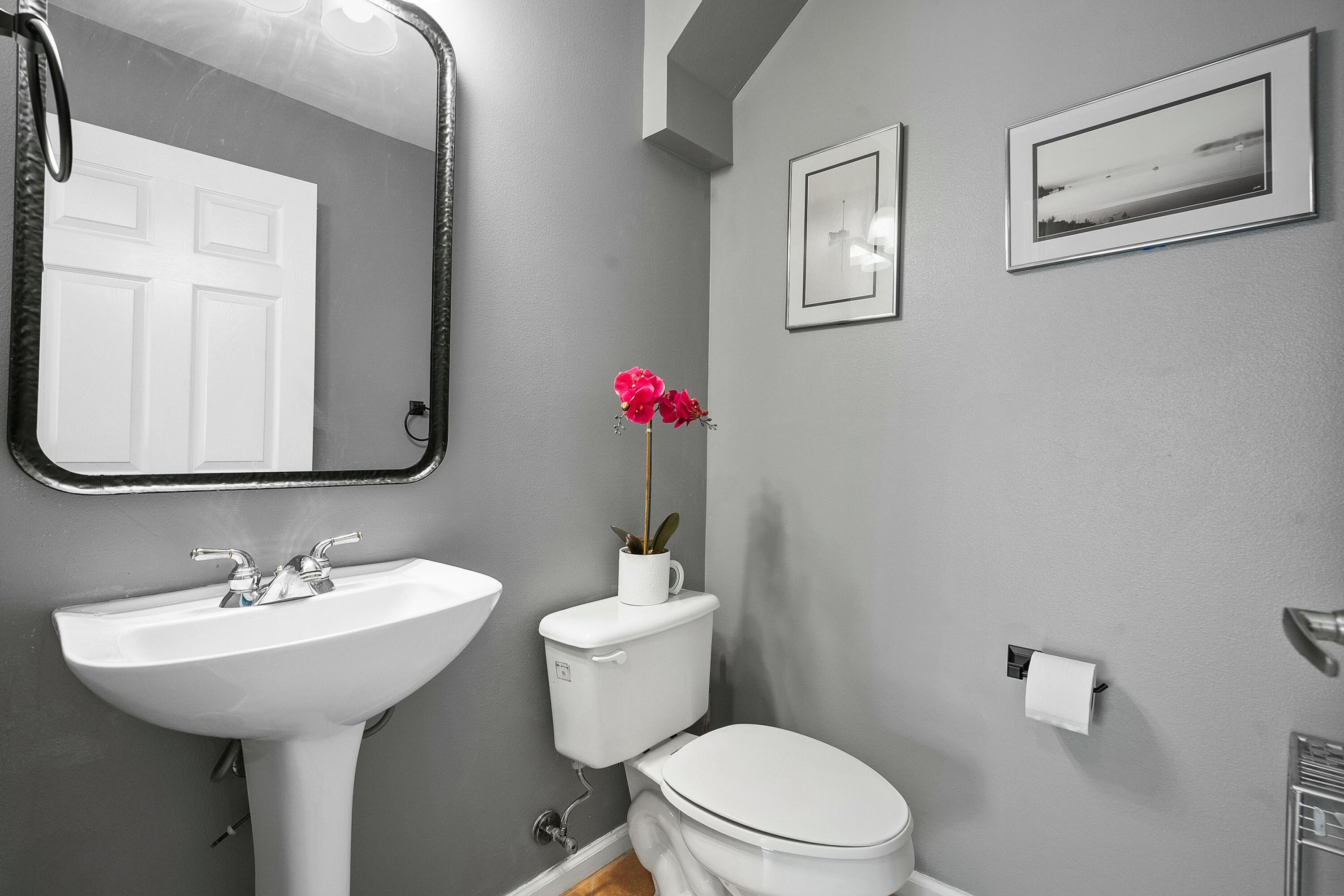 2480 Southeast Springtree Place Stuart, FL 34997 - Photo 22 of 39 a bathroom with a toilet sink and mirror