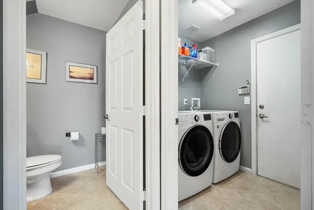 a view of a hallway with washer and dryer