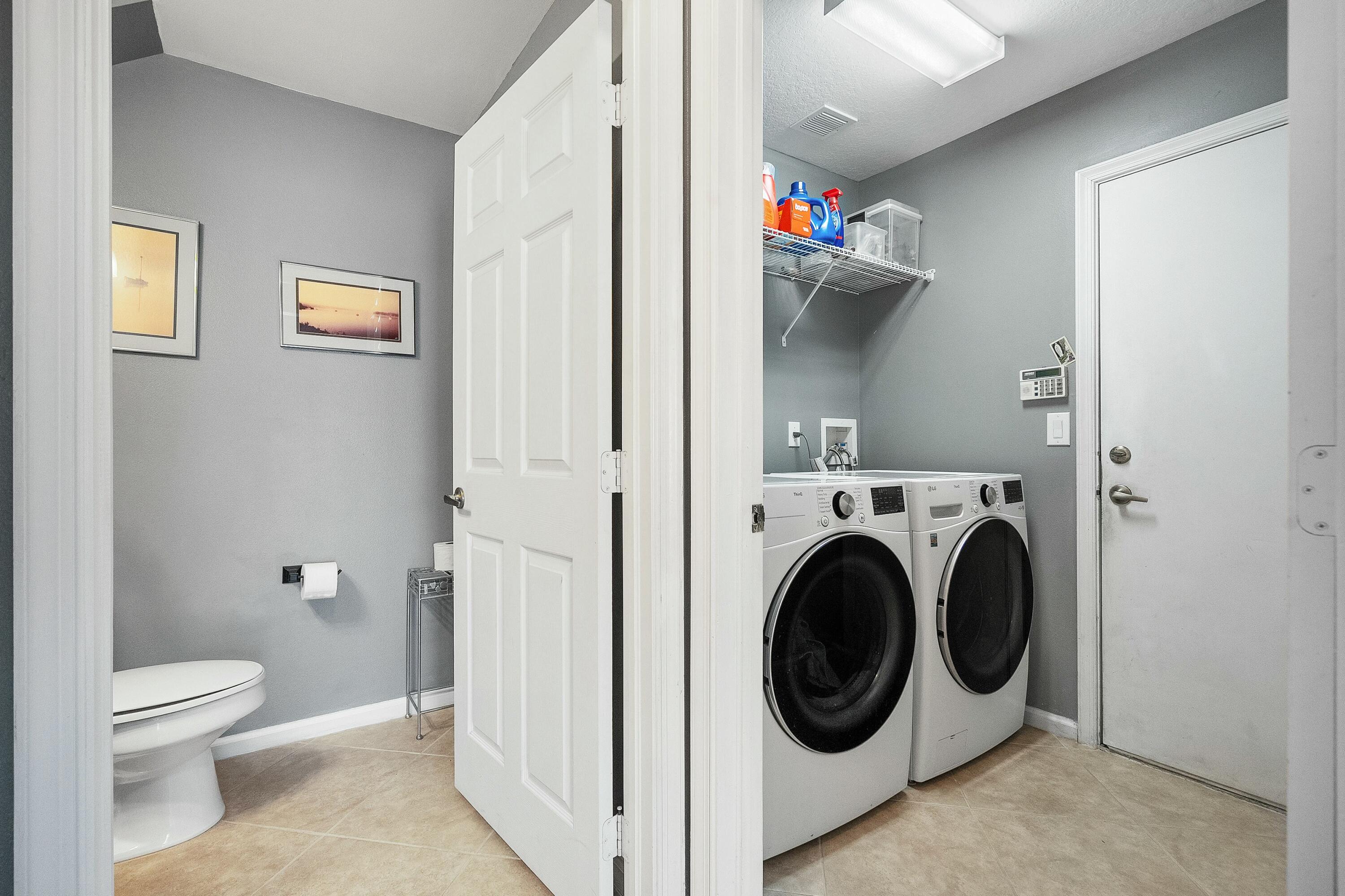 2480 Southeast Springtree Place Stuart, FL 34997 - Photo 23 of 39 a view of a hallway with washer and dryer