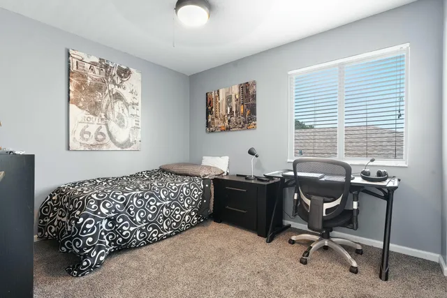 a bedroom with a workspace