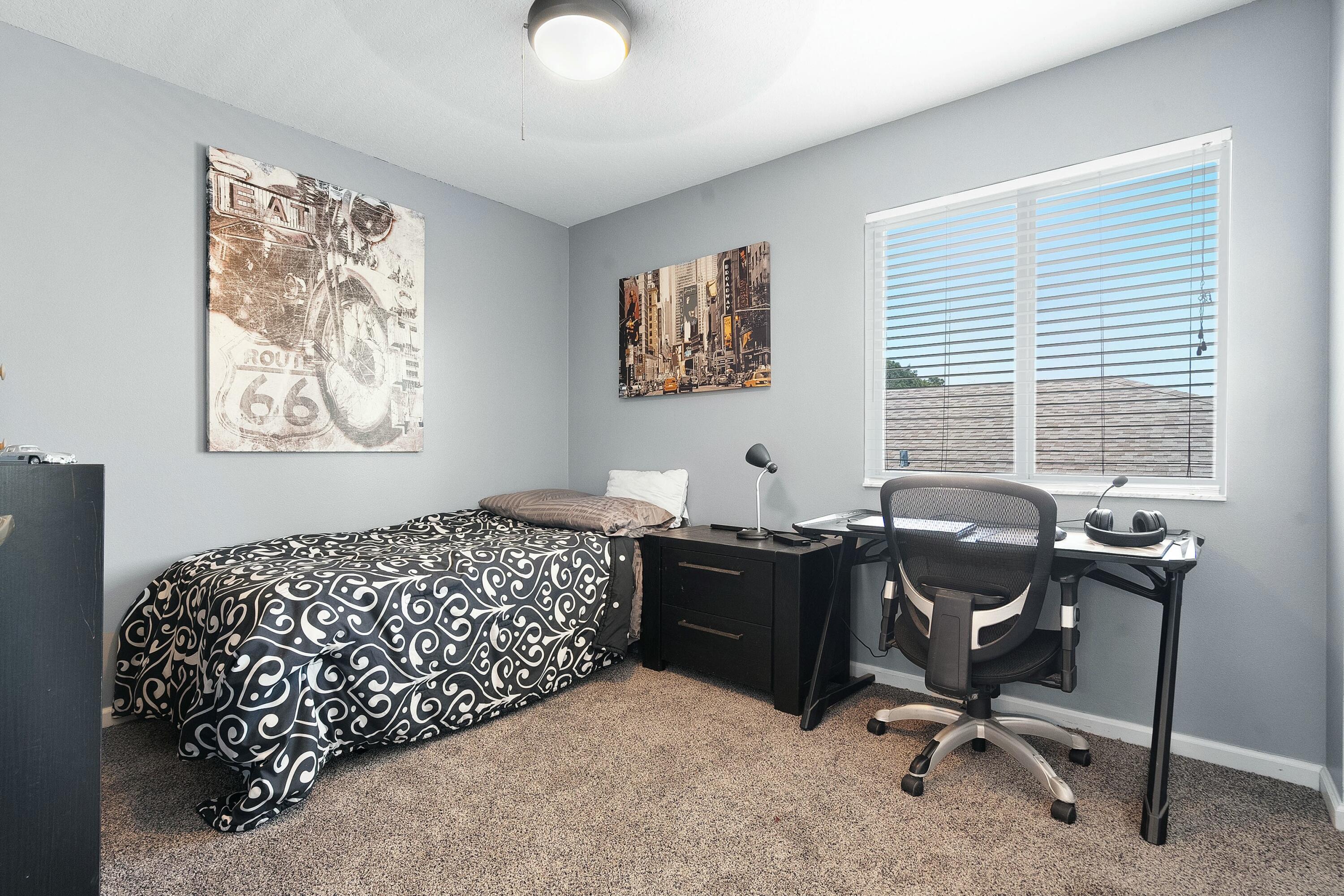 2480 Southeast Springtree Place Stuart, FL 34997 - Photo 25 of 39 a bedroom with a bed and a desk