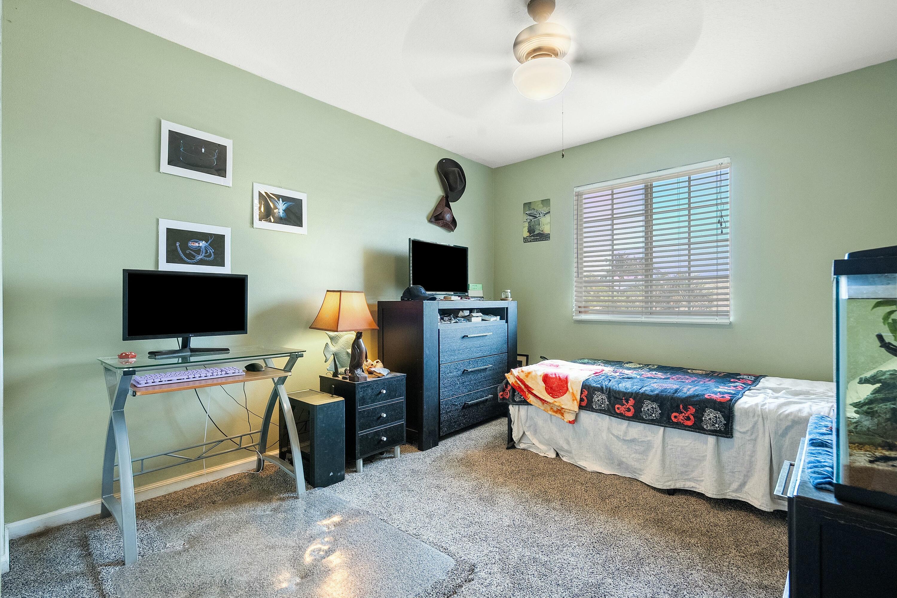 2480 Southeast Springtree Place Stuart, FL 34997 - Photo 26 of 39 a bedroom with a workspace